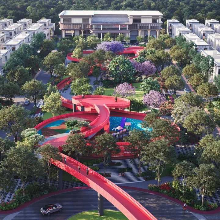 Revasa Là Valora central park aerial with the red elevated walkway looping over the play areas towards Club Valora